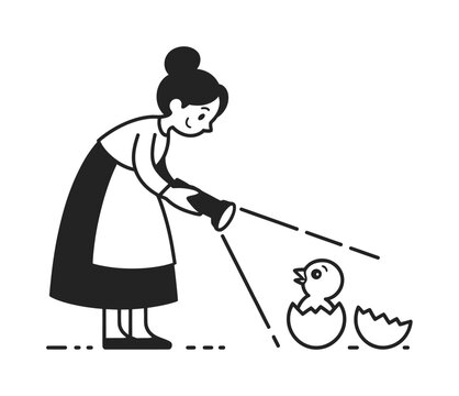 Woman with flashlight shining on a newly hatched chick