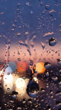 Captivating Raindrops on a Window Pane, Reflecting a Dazzling Cityscape at Dusk with Colorful Lights Glimmering from Behind the Water-logged Glass Surface