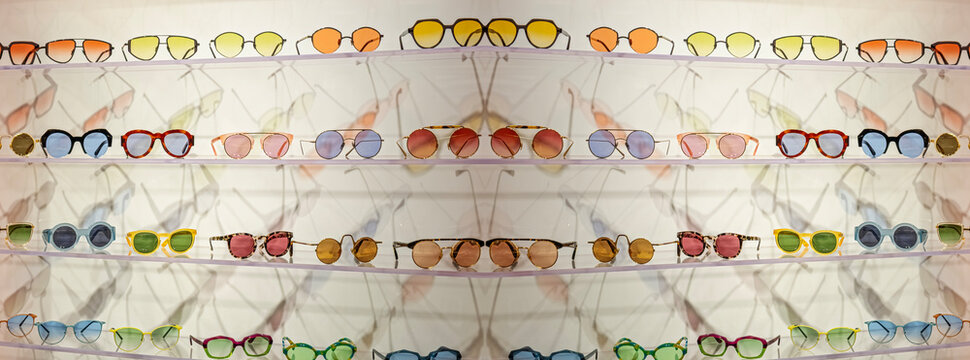 glasses with colored lenses placed on shelves