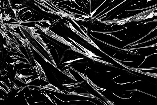 transparent plastic film wrap overlay texture on black background