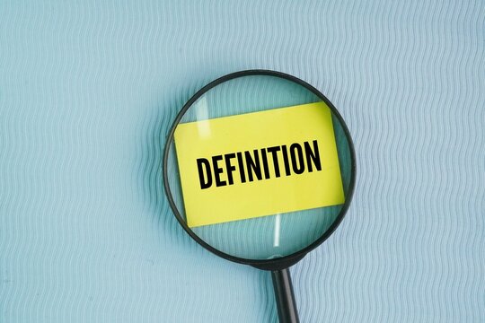 Magnifying glass and paper with the word Definition. formal, precise statement that explains the exact meaning of a word, phrase, or concept