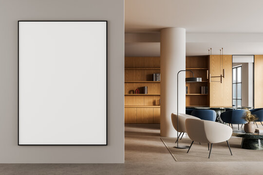 Minimalist interior featuring large empty poster mockup on neutral wall next to contemporary living area with wooden shelves and modern furniture. 3D Rendering
