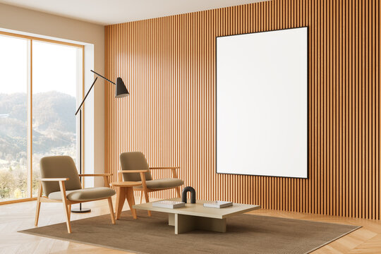 Modern interior with large blank framed poster mockup on wooden slat wall in bright minimalist living room with chairs and window view. 3D Rendering