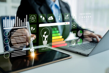 Fototapeta premium A business professional analyzes energy efficiency data using advanced digital tools and interactive charts, emphasizing the importance of sustainable practices and innovative solutions. Ledger