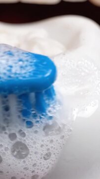 Close-Up of a Toothbrush Gathering Foam from Toothpaste, Highlighting Oral Hygiene and Cleanliness in Daily Dental Care Routine