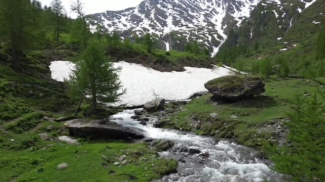 Europe, Italy, Alpeggio Balma di Rodoretto , Prali , Turin is a small mountain village with a stream of water due to the melting of the glacier ice - climate change and global warming save the planet