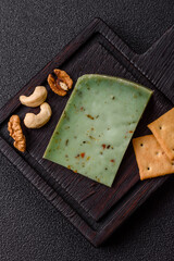 Obraz premium Hard green pesto cheese with herbs as a pasta ingredient. Green pesto cheese
