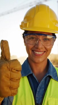 Confident Woman in Safety Gear Smiling Under Construction Site Environment with Helmet and Protective Glasses
