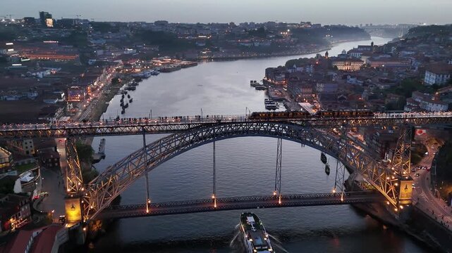 Porto dom luis i bridge at dusk metro train crosses douro river