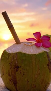 A Refreshing Tropical Coconut Drink Embellished with a Vibrant Pink Flower and a Lime Slice, Capturing the Essence of Sunset Relaxation by the Beach