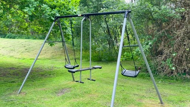 Empty swing set in green garden