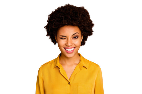 Closeup photo of funny beautiful pretty dark skin wavy lady positive good mood flirty blinking one eye wear yellow shirt blouse isolated brown color background