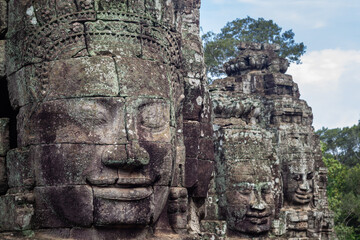 Fototapeta premium Close up view of the giant smiling stone faces of Avalokiteshvara at the ancient Bayon temple in Angkor Thom Cambodia