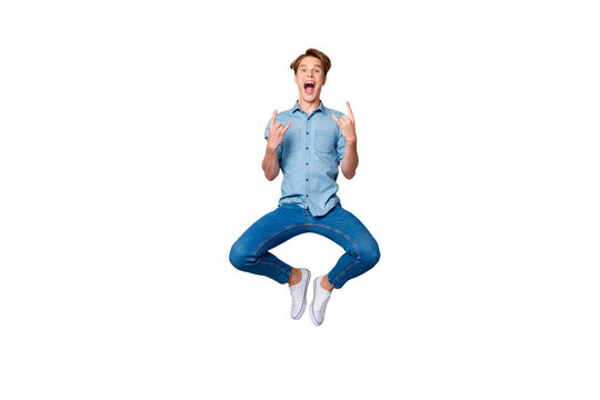 Full size photo of crazy funky hipster guy visit pank music concert feel rejoice jump show horned signs wear casual style outfit isolated over grey color background
