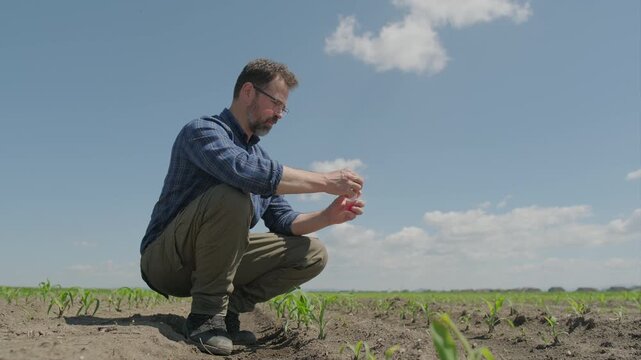 Agronomist collecting soil sample in plastic vial container, Part 2