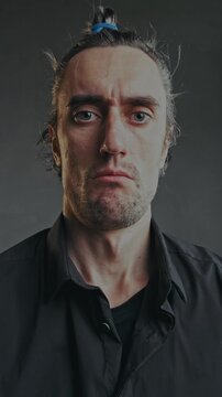 Serious Funny Man Stares at Camera and Blinks