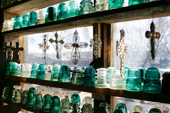 Vintage glass insulators displayed in a window