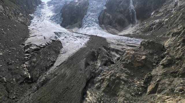 Aerial drone flight toward glacier and waterfall in Norwegian mountains

Description:

Drone footage flying toward a dramatic glacier with blue ice formations and cascading waterfall surrounded by roc