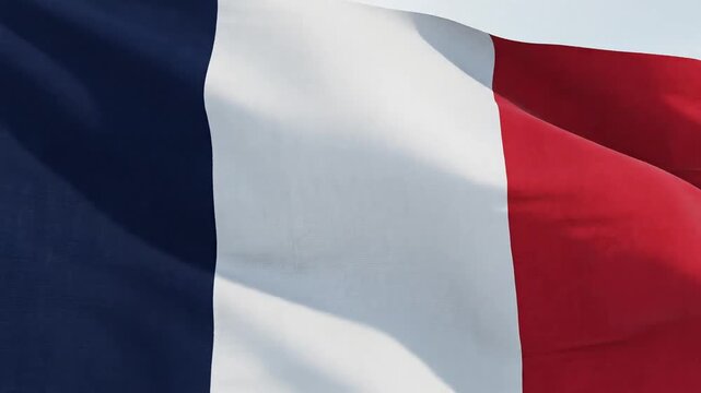 Waving French flag in the wind, symbolizing patriotism and national pride.