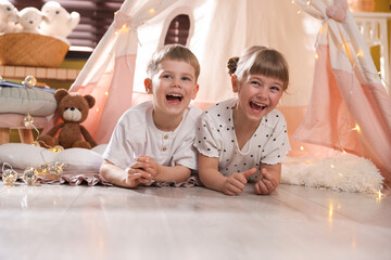 Little girl and boy near wigwam at home © New Africa
