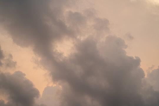 Dramatic clouds with soft hues during sunset, creating a serene atmosphere.