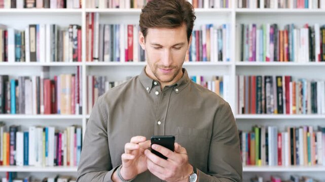 Teacher, research and happy man with phone in library for academic study, knowledge or information. Male person, user or professor scrolling with smile on smartphone for online curriculum or syllabus