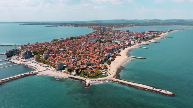 High angle drone view of Nessebar old town red tile roofs density cityscape surrounded by blue sea water summer vacation travel background Bulgaria