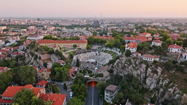 Plovdiv old town traditional houses with red roofs and church bell tower on Nebet Tepe hill panoramic cityscape sunrise summer aerial view Bulgaria