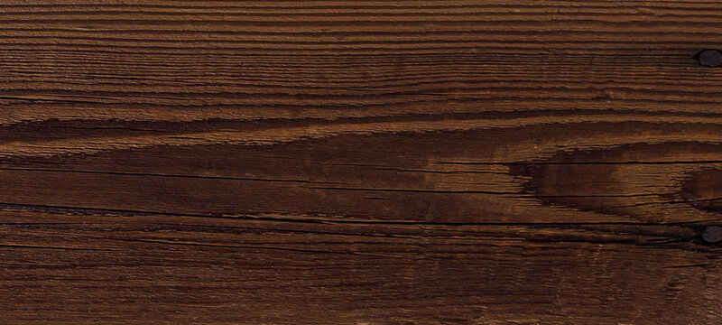 Horizontal dark wood plank texture featuring linear grain and small knots for rustic background design and natural timber surface details in warm brown tones suitable for furniture and flooring look