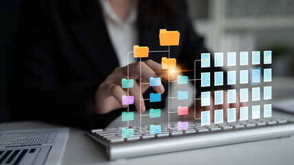 Hands on keyboard interacting with digital file management system and folder organization interface...
