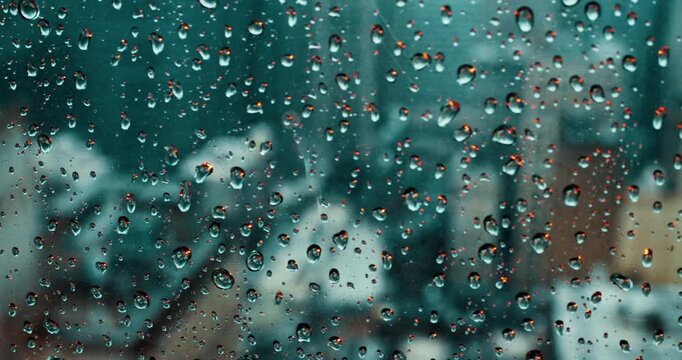 Raindrops on Skyscraper Window with Cityscape View
