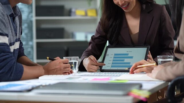 Businessman collaborate on project analysis with financial graphs. Strategic teamwork and insights drive company growth and success.