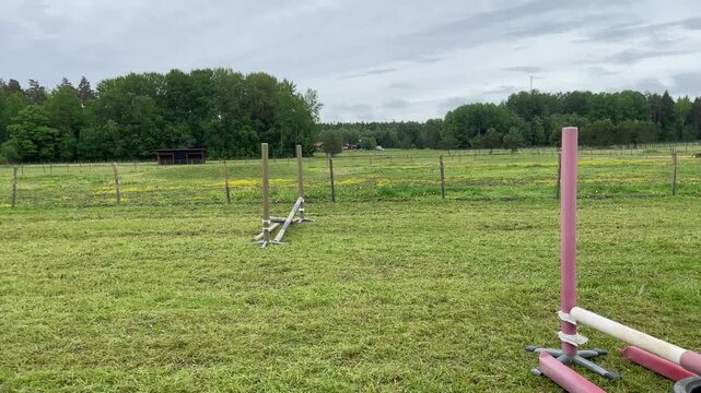 Pink horse obstacle at riding school. Ready to jump and practice. Summer day in June.