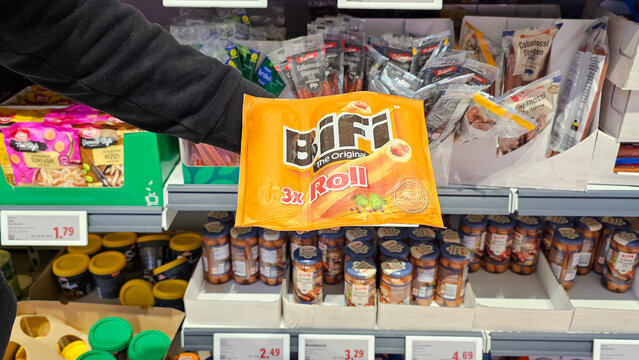 Hand holding bifi roll package in supermarket