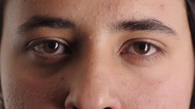 Optometry, face and eyes with assessment, optical test or glaucoma screening in vision care. Portrait, retina and person with closeup, eyesight examination or visual tracking for ocular wellness.