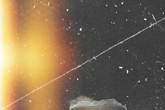 Vintage film scan overlay, single long thin scratch line, scattered dust specks, intense warm orange light leak left edge burn, dark analog grain noise, damaged cinematic grunge effect PNG