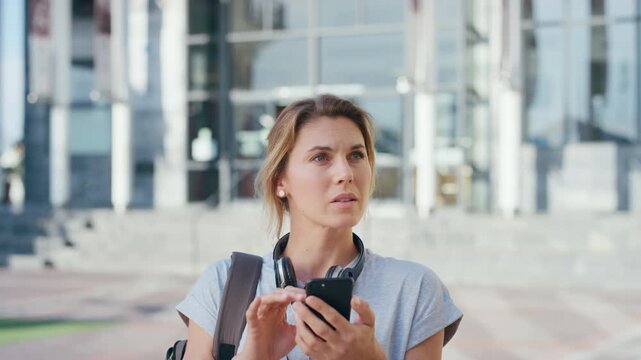 Woman, confused and phone in city for travel with search for location, click and holiday on getaway. Person, backpack or frustrated with thinking, mobile app and direction in urban town with vacation