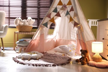Beautiful wigwam, cushions and toys in child's room © New Africa