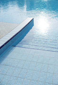 Swimming pool details in summer. Pool with clean water.