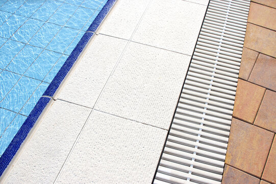 Swimming pool details in summer. Pool with clean water.