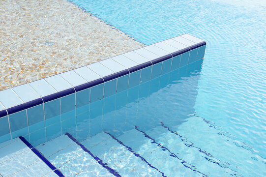 Swimming pool details in summer. Pool with clean water.