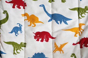 Colourful Dinosaur Pattern on Wrinkled Fabric Background © Goran