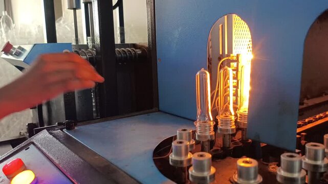 ​Operator Controlling and Loading PET Preforms into Semi-Automatic Blow Molding Machine