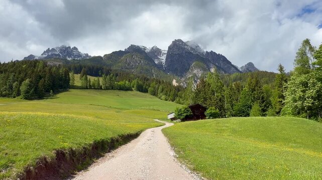 Alpine scenery with old wooden hayloft under high mountains, Leogang, Austria