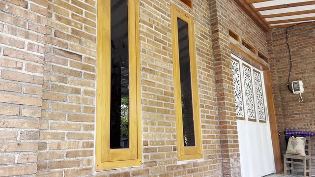 Rustic Red Brick Wall Architecture with Modern Orange Wooden Window Frame