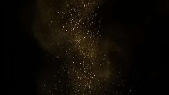 Glowing particles burst upwards in a mesmerizing display of light and energy against a dark backdrop.