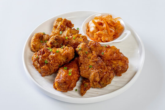 crispy fried korean chicken  in galbi sauce with pickled, kimchi, and rice side dishes