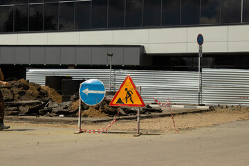 Fototapeta premium Temporary road signs at an urban street construction and repair site