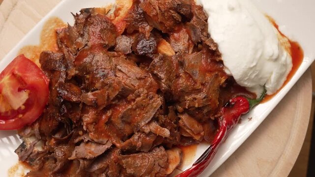 Traditional Turkish Iskender Kebab served with tomato sauce, yogurt, and grilled peppers, fa01