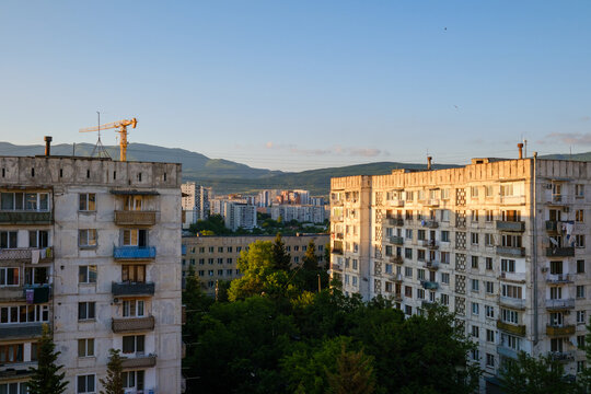 Horizontal landscape photograph capturing typical concrete panel housing buildings during blue hour in the Mukhiani district of Tbilisi